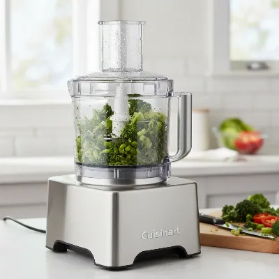 Cuisinart 14-Cup Food Processor actively chopping vegetables in a modern kitchen setting